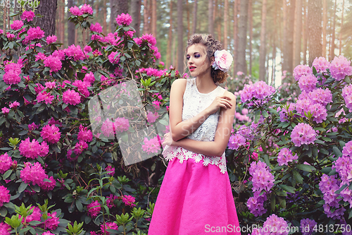 Image of girl in dress in rhododendron garden