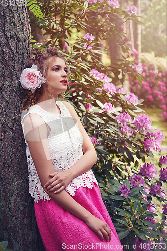 Image of girl in dress in rhododendron garden