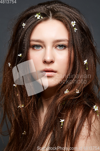 Image of girl with many small flowers in long hair