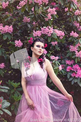 Image of girl in dress in rhododendron garden