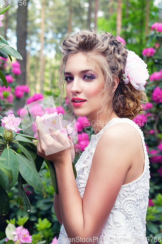 Image of girl in dress in rhododendron garden