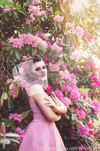 Image of girl in dress in rhododendron garden