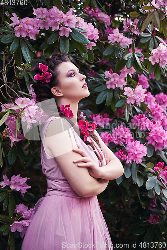 Image of girl in dress in rhododendron garden