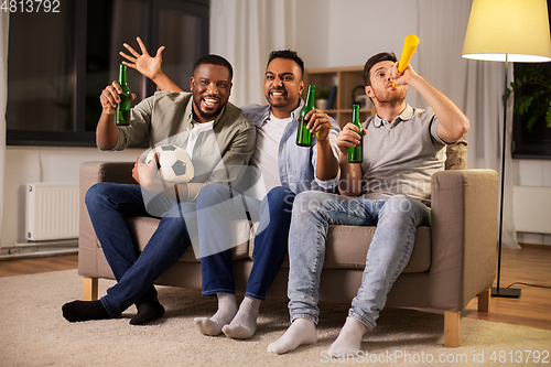 Image of friends or soccer fans with ball and beer at home