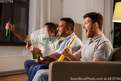 Image of friends or soccer fans with ball and beer at home