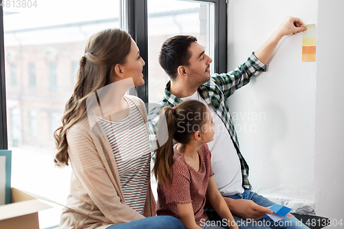 Image of happy family with color palette moving to new home