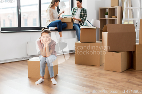 Image of sad girl moving to new home with her family
