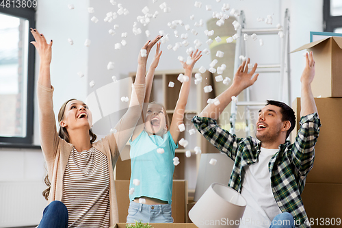 Image of happy family playing with foam peanuts at new home