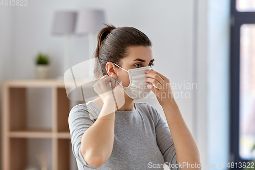 Image of young woman wearing protective medical mask