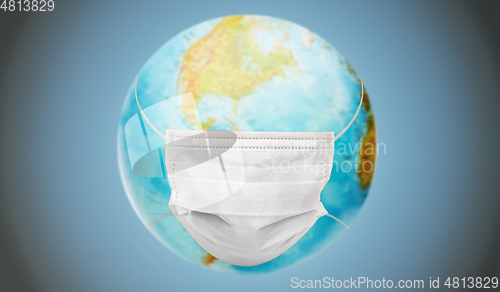 Image of earth planet globe in protective medical mask