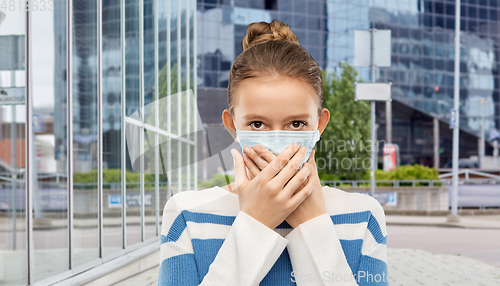 Image of teenage girl in protective medical mask at city