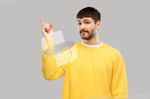 Image of man pointing finger to something