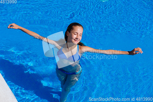 Image of teen girl relaxing near swimming pool