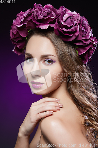 Image of beautiful girl with purple makeup and flowers