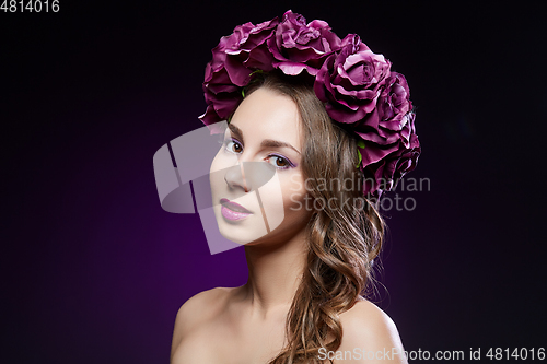 Image of beautiful girl with purple makeup and flowers