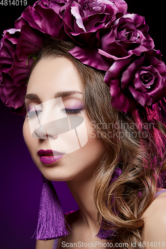 Image of beautiful girl with purple makeup and flowers