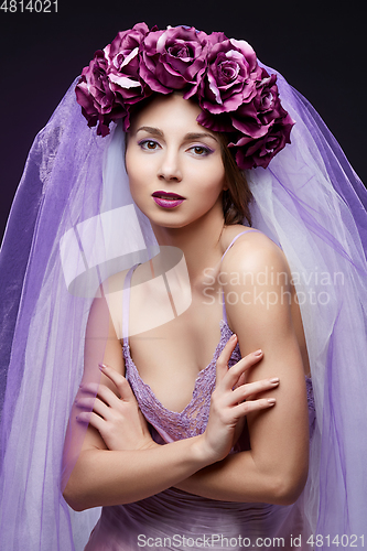 Image of beautiful girl with purple makeup and flowers