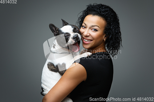 Image of young woman with french bulldog dog