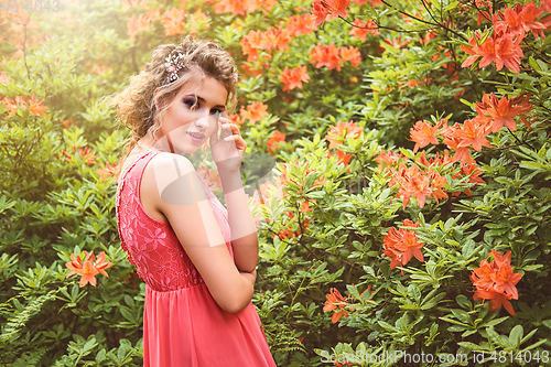 Image of girl in dress in rhododendron garden