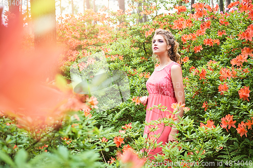 Image of girl in dress in rhododendron garden