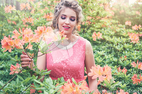 Image of girl in dress in rhododendron garden