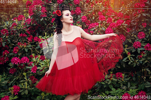 Image of girl in dress in rhododendron garden