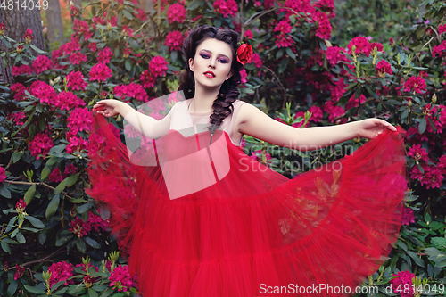 Image of girl in dress in rhododendron garden