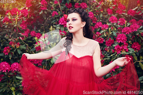 Image of girl in dress in rhododendron garden