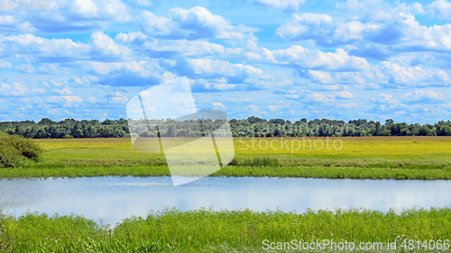 Image of summer landscape with lake field and clouds