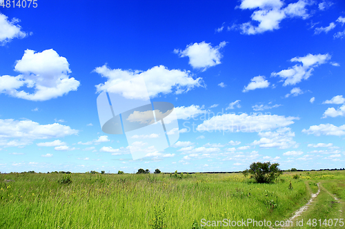 Image of summer landscape with field country road and clouds