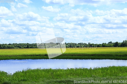 Image of landscape with summer lake field and clouds