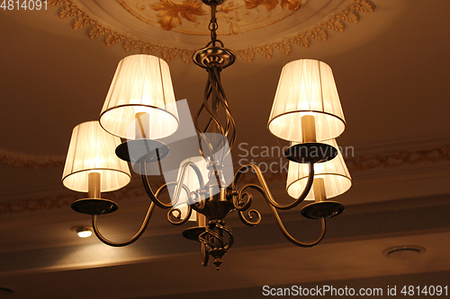 Image of chandelier with romantic standard lamps