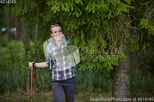 Image of young woman with nordic walk pols