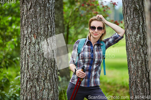 Image of young woman with nordic walk pols