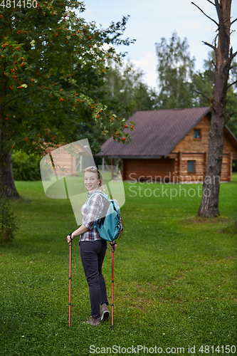 Image of young woman with nordic walk pols