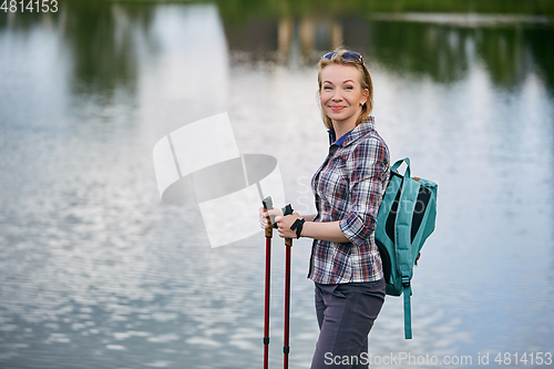 Image of young woman with nordic walk pols