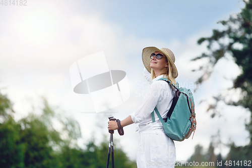 Image of young woman with nordic walk pols