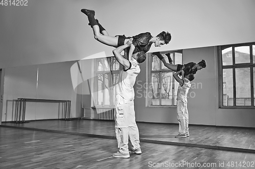 Image of beautiful couple dancing bachata in dance studio