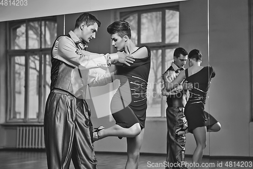 Image of beautiful couple dancing tango