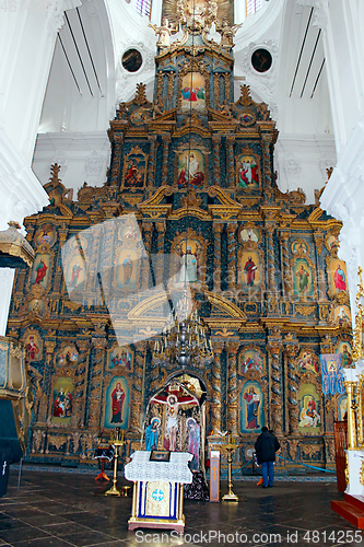 Image of people in the church near beautiful iconostasis