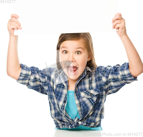 Image of Little girl is holding a blank banner