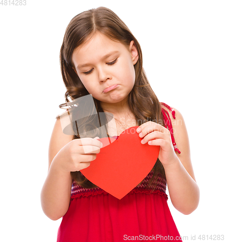 Image of Portrait of a sad little girl in red