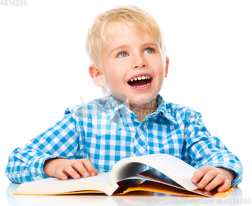 Image of Little child play with book