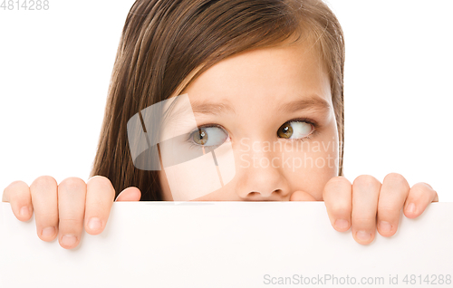 Image of Little girl is looking from out blank board