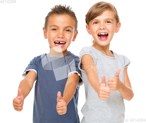 Image of Little boy and girl are showing thumb up sign