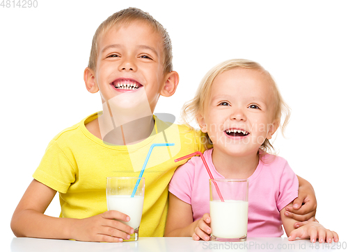 Image of Cute little girl and boy are drinking milk