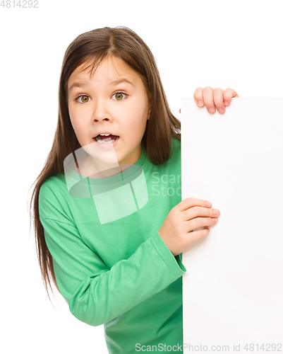 Image of Little girl is looking out from the blank banner