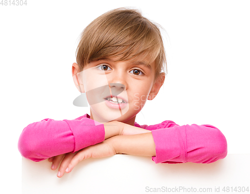 Image of Little girl is looking out from the blank banner