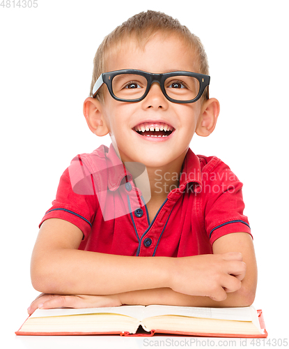 Image of Little boy is reading a book