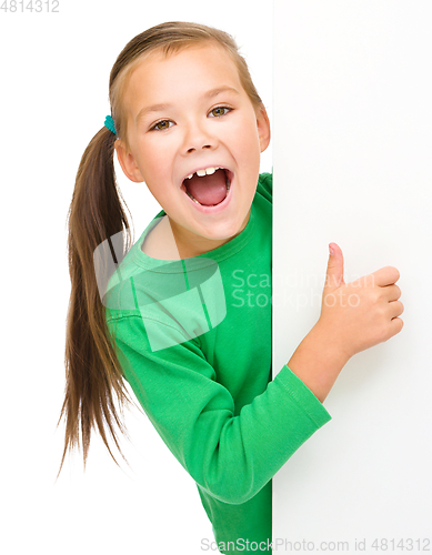 Image of Little girl is looking from out blank board